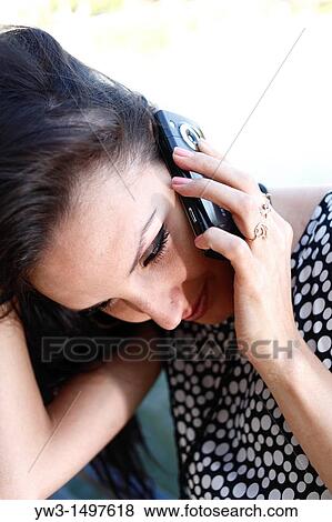 25 year old pretty woman outdoors talking by cell phone View Large Photo Image Stock Photo - 25 year old pretty woman outdoors talking by cell phone. Fotosearch