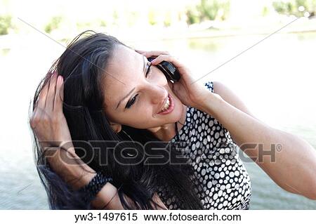 25 year old pretty woman outdoors talking by cell phone View Large Photo Image Stock Photography - 25 year old pretty woman outdoors talking by cell phone. Fotosearch
