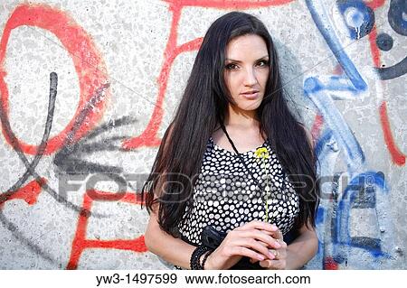 25 year old woman outdoors against graffiti View Large Photo Image Stock Photo - 25 year old woman outdoors against graffiti. Fotosearch