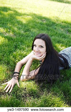 25 year old woman outdoors on the grass View Large Photo Image Stock Image - 25 year old woman outdoors on the grass. Fotosearch