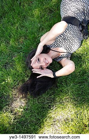 25 year old woman outdoors on the grass View Large Photo Image Stock Image - 25 year old woman outdoors on the grass. Fotosearch