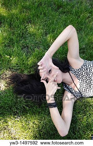 25 year old woman outdoors on the grass View Large Photo Image Stock Image - 25 year old woman outdoors on the grass. Fotosearch
