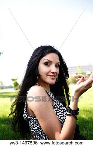 25 year old woman outdoors on the grass View Large Photo Image Stock Photograph - 25 year old woman outdoors on the grass. Fotosearch