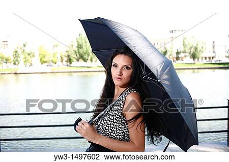 25 year old woman outdoors with umbrella View Large Photo Image Stock Image - 25 year old woman outdoors with umbrella. Fotosearch