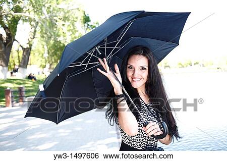 25 year old woman outdoors with umbrella View Large Photo Image Stock Photograph - 25 year old woman outdoors with umbrella. Fotosearch