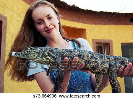 25 year old woman with caiman. View Large Photo Image Stock Photograph - 25 year old woman with caiman.. Fotosearch