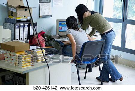 25 year old young women in office using internet View Large Photo Image Stock Image - 25 year old young women in office using internet. Fotosearch