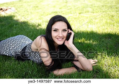 25 years pretty women outdoors on the grass with cell phone View Large Photo Image Stock Photo - 25 years pretty women outdoors on the grass with cell phone. Fotosearch