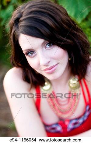 26 year old brunette woman wearing a red dress in a field of sunflowers View Large Photo Image Picture - 26 year old brunette woman wearing a red dress in a field of sunflowers. Fotosearch