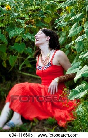 26 year old brunette woman wearing a red dress in a field of sunflowers View Large Photo Image Stock Image - 26 year old brunette woman wearing a red dress in a field of sunflowers. Fotosearch