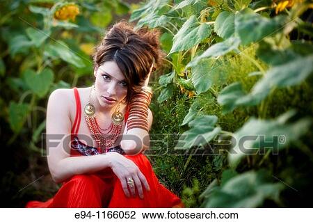26 year old brunette woman wearing a red dress in a field of sunflowers View Large Photo Image Stock Image - 26 year old brunette woman wearing a red dress in a field of sunflowers. Fotosearch