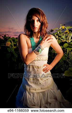 26 year old brunette woman wearing a white dress in a field of sunflowers View Large Photo Image Stock Photo - 26 year old brunette woman wearing a white dress in a field of sunflowers. Fotosearch
