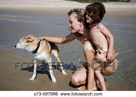 Stock Photo - 27 year old woman, girl (3 year old) and dog. Fotosearch