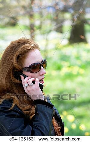28 year old redheaded woman talking on a mobile phone View Large Photo Image Stock Image - 28 year old redheaded woman talking on a mobile phone. Fotosearch