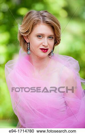 29 year old blond woman in a garden setting wrapped in pink fabric View Large Photo Image Stock Image - 29 year old blond woman in a garden setting wrapped in pink fabric. Fotosearch