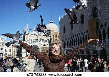 29 year old woman with pigeons in St Mark's Square, Venice. Veneto, Italy View Large Photo Image Stock Photo - 29 year old woman with pigeons in St Mark's Square, Venice. Veneto, Italy. Fotosearch