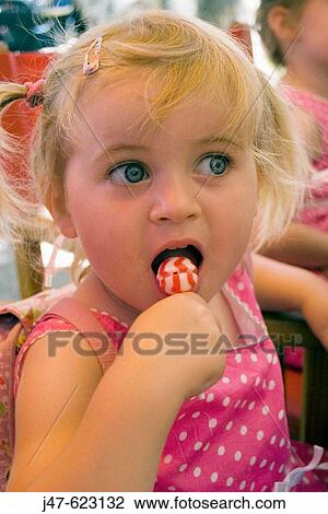 2_3 year old girl sucking a lolly, eyes wide open View Large Photo Image Stock Image - 2_3 year old girl sucking a lolly, eyes wide open. Fotosearch