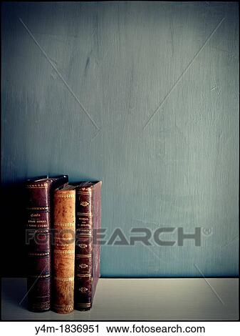 3 antique books on empty grey background View Large Photo Image Stock Image - 3 antique books on empty grey background. Fotosearch
