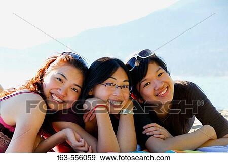 3 asian women laying on towel at the beach View Large Photo Image Stock Photo - 3 asian women laying on towel at the beach. Fotosearch