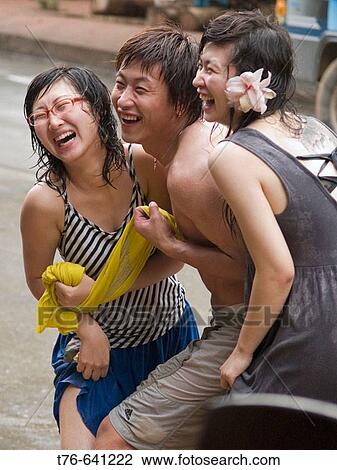 3 Chinese tourists laugh during the wild and wet Songkran Lao New Year Festival, Luang Prabang, Laos View Large Photo Image Stock Image - 3 Chinese tourists laugh during the wild and wet Songkran Lao New Year Festival, Luang Prabang, Laos. Fotosearch