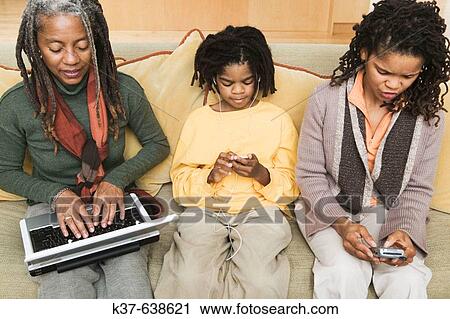 3 generations of African American family at home, with grandma using laptop being advised by older daughter & her grandson listening to his ipod. View Large Photo Image Stock Image - 3 generations of African American family at home, with grandma using laptop being advised by older daughter & her grandson listening to his ipod.. Fotosearch
