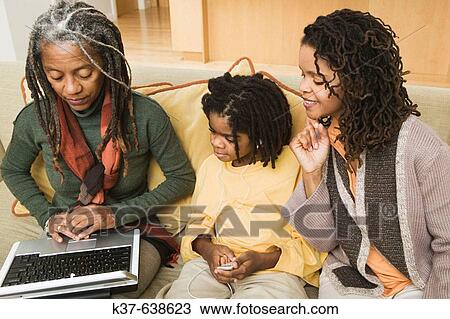 3 generations of African American family at home, with grandma using laptop being advised by older daughter & her grandson listening to his ipod. View Large Photo Image Stock Image - 3 generations of African American family at home, with grandma using laptop being advised by older daughter & her grandson listening to his ipod.. Fotosearch