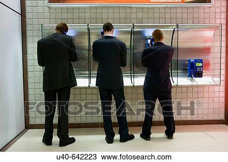3 men on airport payphones View Large Photo Image Stock Image - 3 men on airport payphones. Fotosearch