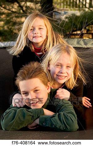 3 siblings, ages 10, 8 and 5 View Large Photo Image Picture - 3 siblings, ages 10, 8 and 5. Fotosearch