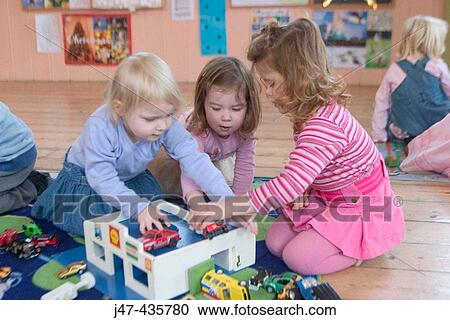 3 three year old girls playing with cars on the floor View Large Photo Image Stock Image - 3 three year old girls playing with cars on the floor. Fotosearch