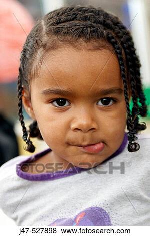 3 Year Old Black Girl Playing At Nursery Pulling A Face Into