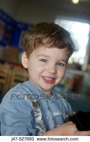 3 year old boy looking into camera at nursery, View Large Photo Image Stock Image - 3 year old boy looking into camera at nursery,. Fotosearch