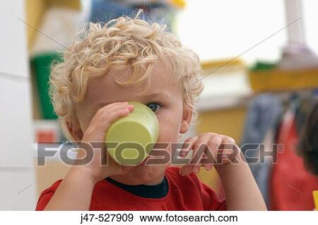 3 year old boy, looking into camera, at nursery, drinking a glass of milk View Large Photo Image Stock Photo - 3 year old boy, looking into camera, at nursery, drinking a glass of milk. Fotosearch
