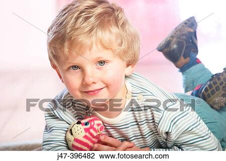 3 year old boy lying on his tummy, smiling into camera View Large Photo Image Stock Image - 3 year old boy lying on his tummy, smiling into camera. Fotosearch