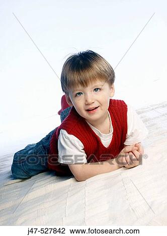 3 year old boy, lying on his tummy smiling into camera View Large Photo Image Stock Image - 3 year old boy, lying on his tummy smiling into camera. Fotosearch