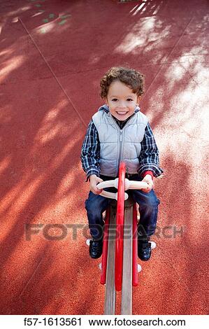 3 year old boy playing in a playground View Large Photo Image Stock Image - 3 year old boy playing in a playground. Fotosearch