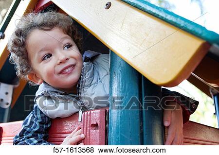 3 year old boy playing in a playground View Large Photo Image Stock Photo - 3 year old boy playing in a playground. Fotosearch