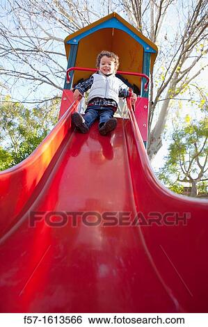 3 year old boy playing in a playground View Large Photo Image Stock Photograph - 3 year old boy playing in a playground. Fotosearch