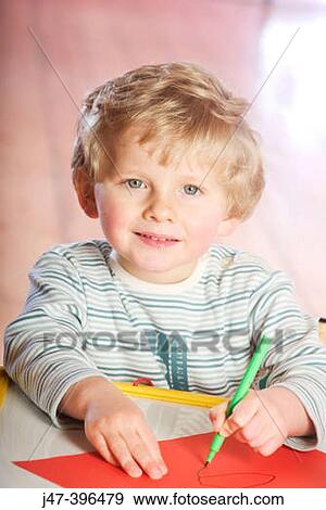 3 year old boy sitting at a desk, drawing, smiling into camera View Large Photo Image Stock Photo - 3 year old boy sitting at a desk, drawing, smiling into camera. Fotosearch