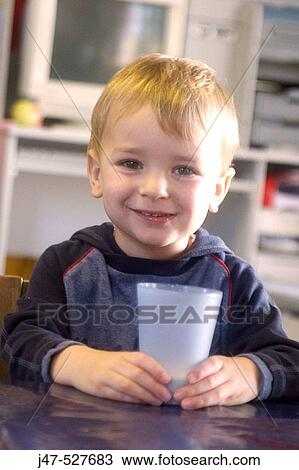3 year old boy smiling into camera at nursery, holding a cup of milk View Large Photo Image Stock Image - 3 year old boy smiling into camera at nursery, holding a cup of milk. Fotosearch
