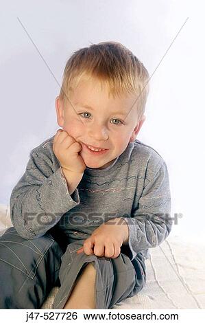 3 year old boy, smiling into camera sitting on the floor in studio View Large Photo Image Stock Photograph - 3 year old boy, smiling into camera sitting on the floor in studio. Fotosearch