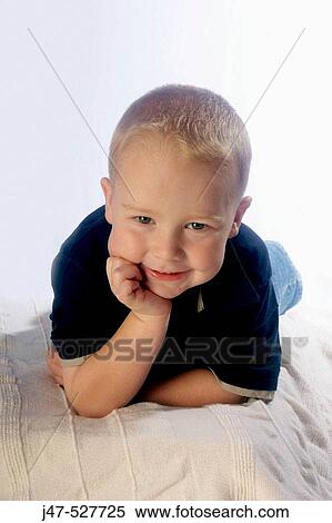 3 year old boy, smiling into camera lying on the floor View Large Photo Image Stock Photography - 3 year old boy, smiling into camera lying on the floor. Fotosearch