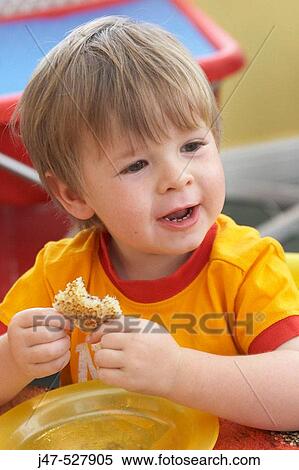 3 year old boy, smiling off camera, at nursery, eating his dinner View Large Photo Image Stock Photography - 3 year old boy, smiling off camera, at nursery, eating his dinner. Fotosearch