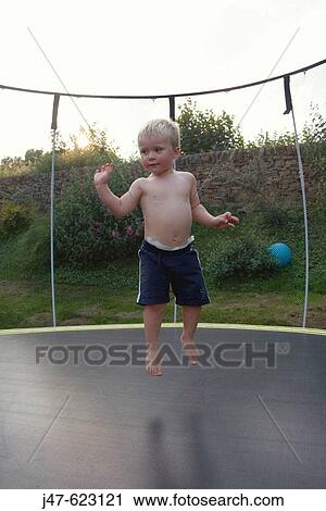 3 year old boys bouncing on a trampoline View Large Photo Image Stock Image - 3 year old boys bouncing on a trampoline. Fotosearch