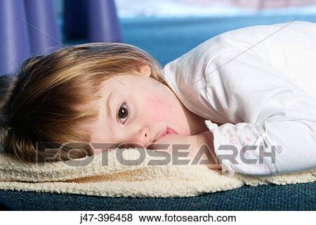 3 year old gir lying on the floor looking off camera, thumb in her mouth View Large Photo Image Stock Photo - 3 year old gir lying on the floor looking off camera, thumb in her mouth. Fotosearch
