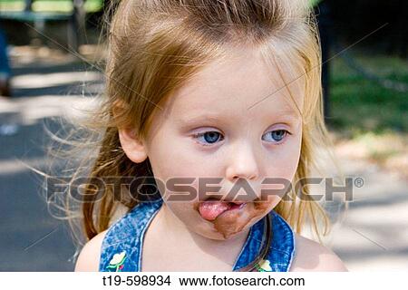 Picture - 3 year old girl after eating an ice cream cone. Boston Public Garden. MR. Fotosearch