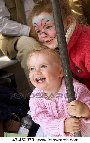 3 year old girl and 18 month old baby girl, swing round a pole, laughing View Large Photo Image Stock Image - 3 year old girl and 18 month old baby girl, swing round a pole, laughing. Fotosearch