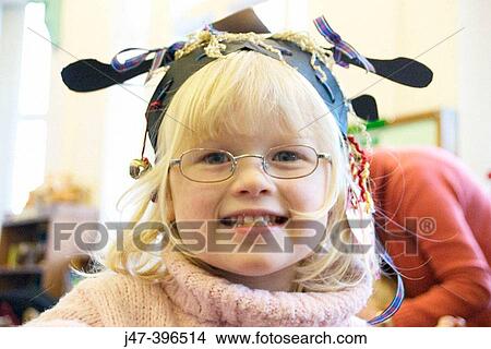 3 year old girl at a party, wearing glasses, smiling into camera View Large Photo Image Picture - 3 year old girl at a party, wearing glasses, smiling into camera. Fotosearch
