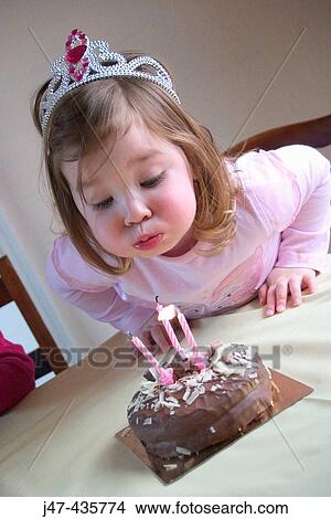 3 year old girl blowing a candle out on her birthday cake cake View Large Photo Image Picture - 3 year old girl blowing a candle out on her birthday cake cake. Fotosearch