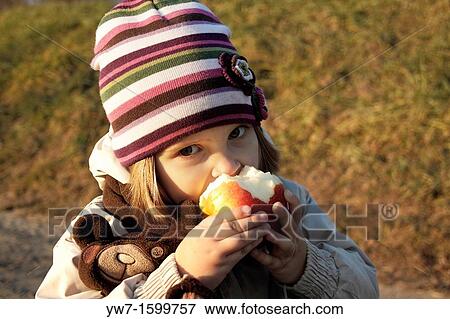 3 year old girl eating an apple View Large Photo Image Stock Photo - 3 year old girl eating an apple. Fotosearch