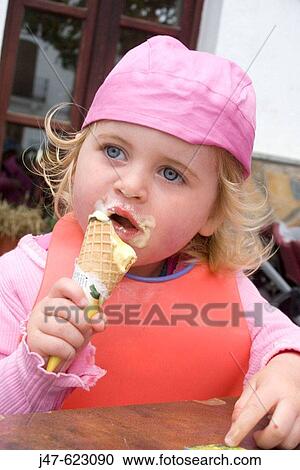 3 year old girl eating an icecream, outside, wearing a bandanna, with it all round her mouth View Large Photo Image Stock Image - 3 year old girl eating an icecream, outside, wearing a bandanna, with it all round her mouth. Fotosearch